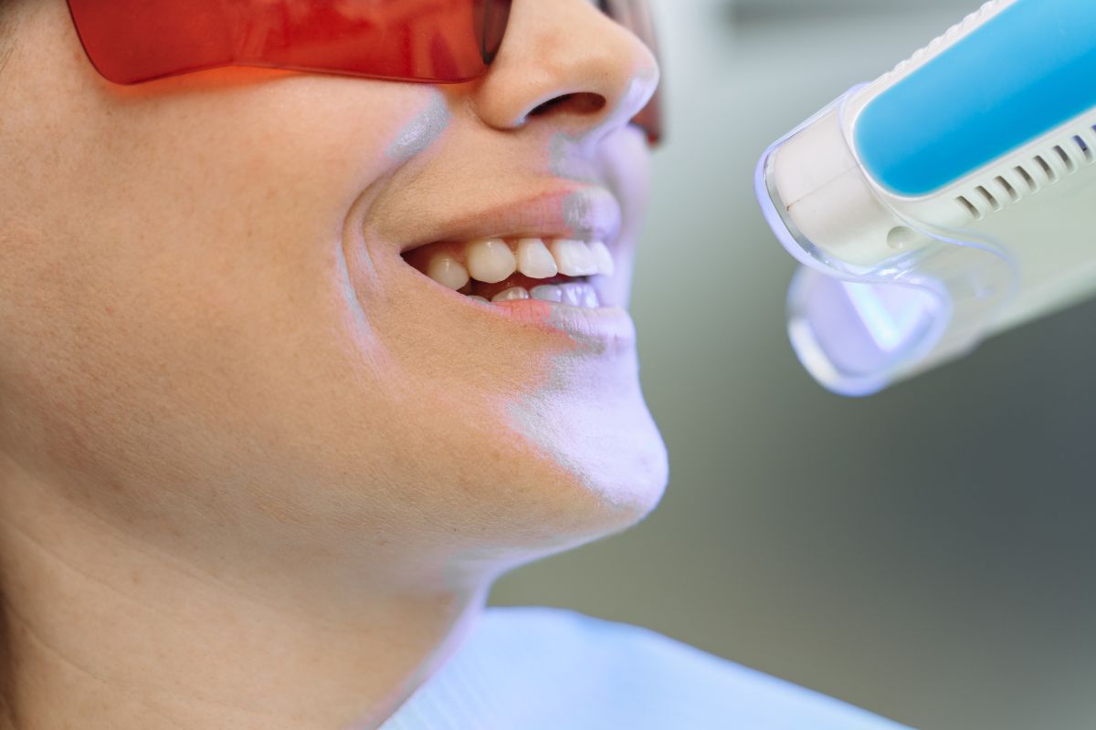a female patients whitening her teeth at the dental office in Colorado Springs